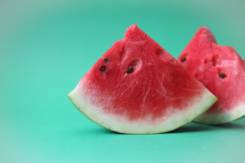 sliced watermelon on green surface