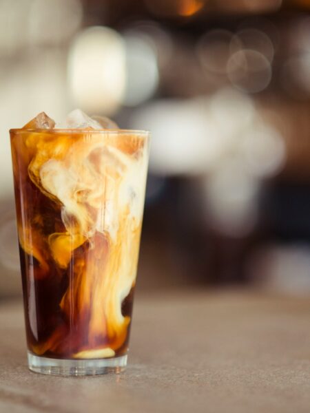 glass cup filled with ice latte on tabletop