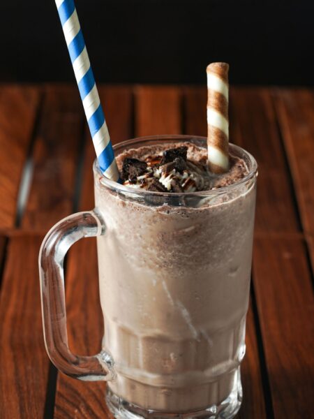 clear glass mug with white and blue striped straw